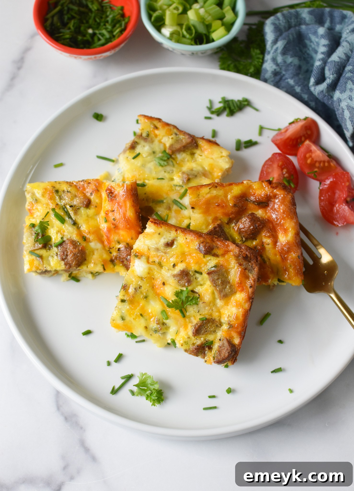 A delicious serving of Cheese and Sausage Baked Eggs, beautifully presented on a plate.