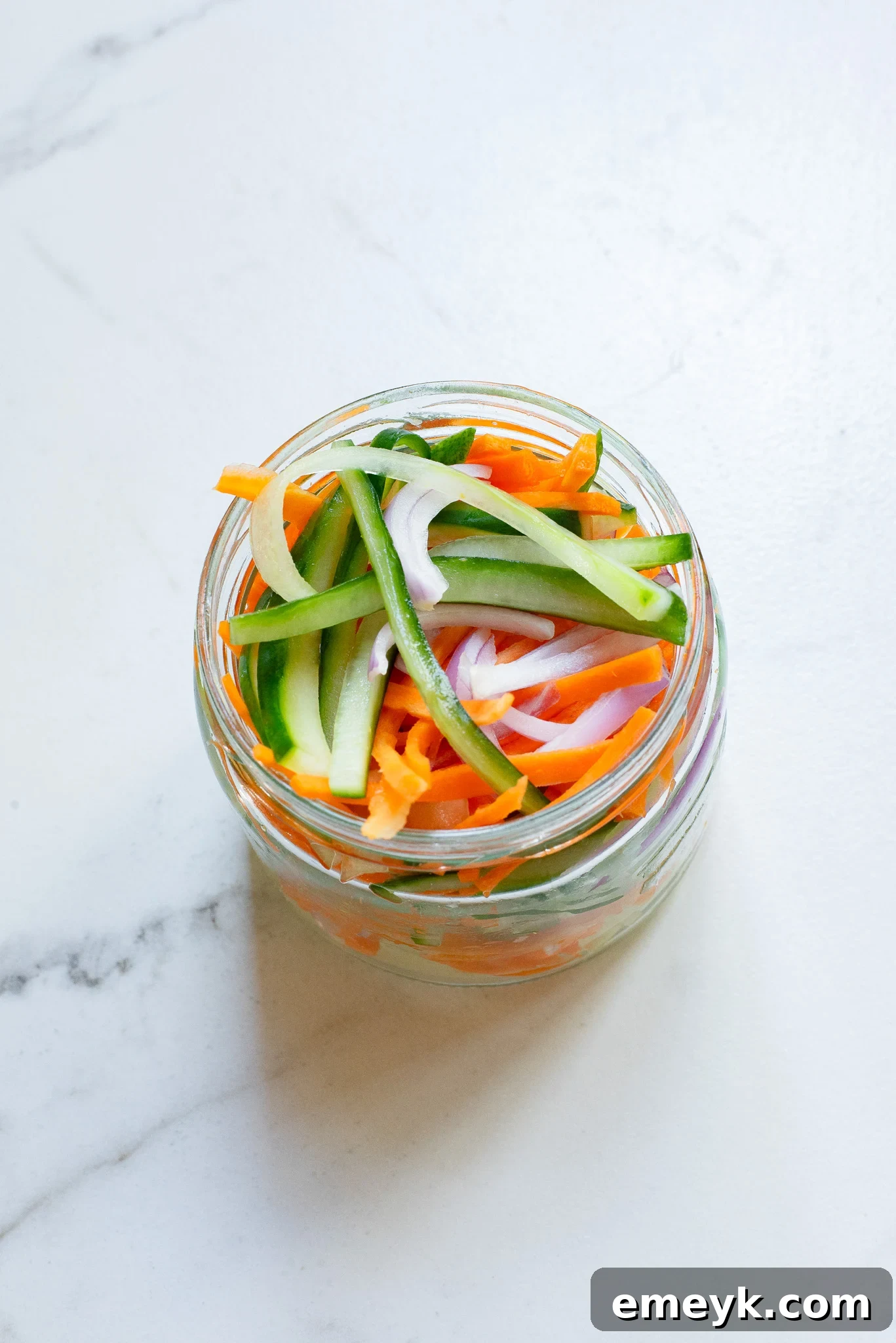 Quick Pickled Vegetables neatly arranged in a clear glass jar, ready for refrigeration.