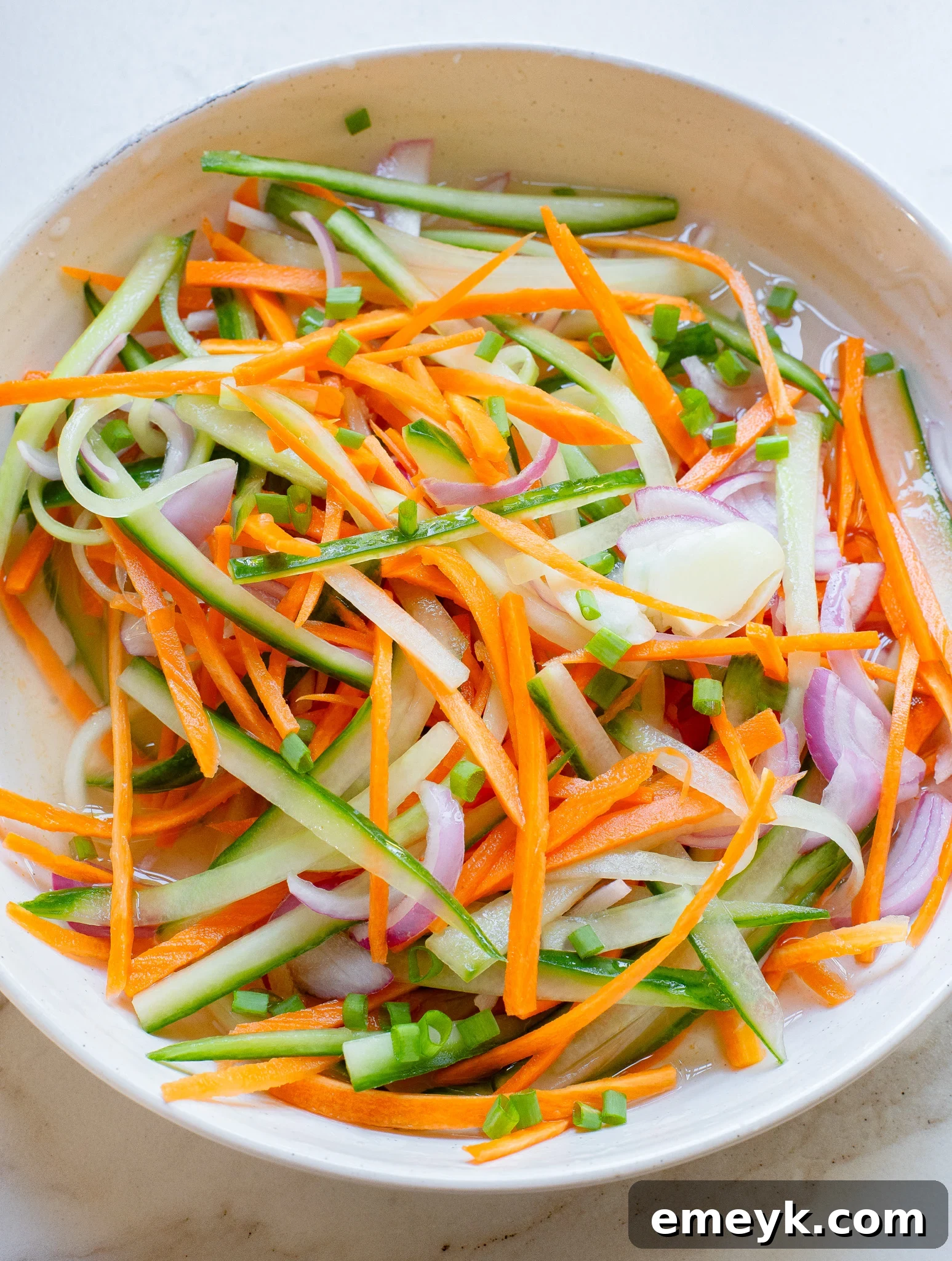 A bowl filled with quick pickled vegetables, ready to be served and enjoyed.