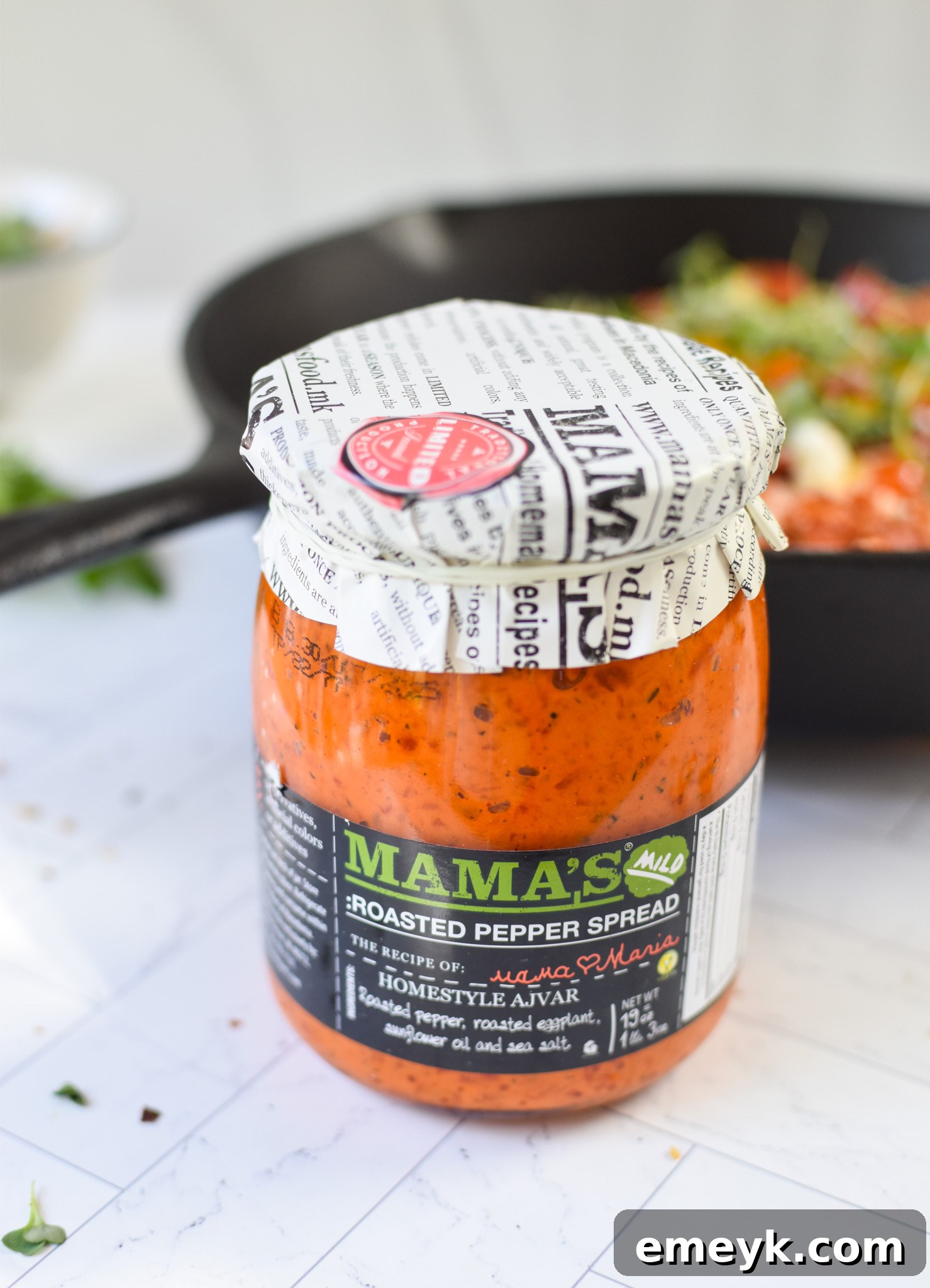 A close-up shot of the vibrant, creamy red pepper sauce, showcasing its smooth texture and rich color, ready to be spread on pizza.