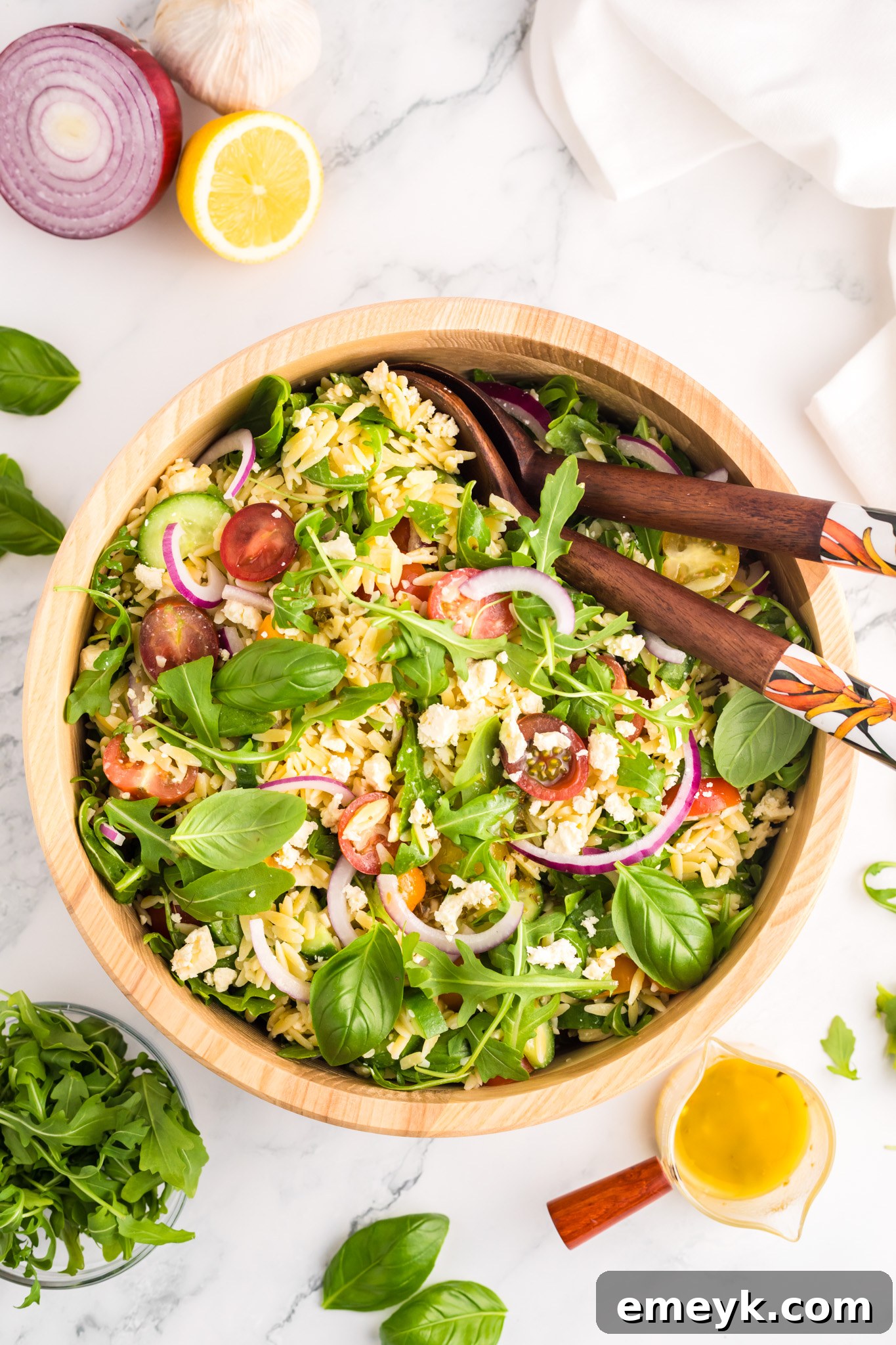 Close-up of Arugula Orzo Salad in a bowl, showing the texture of the ingredients.