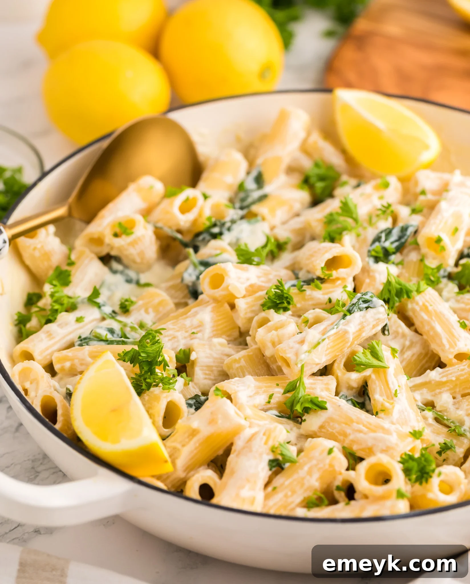 Lemon Ricotta Pasta in a pot with a gold serving spoon, highlighting its creamy texture.