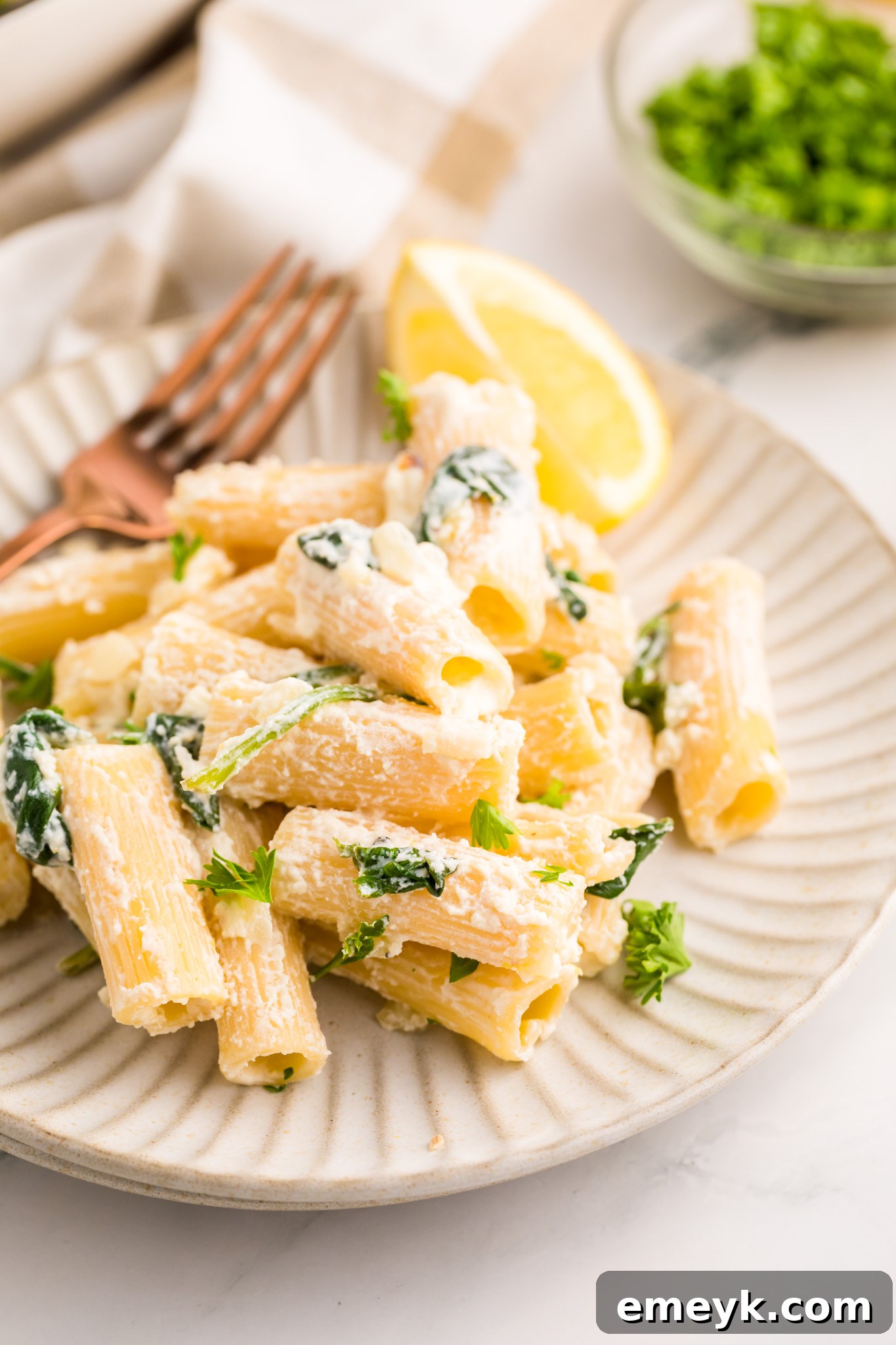Lemon Ricotta Pasta served with a fork, ready to eat.