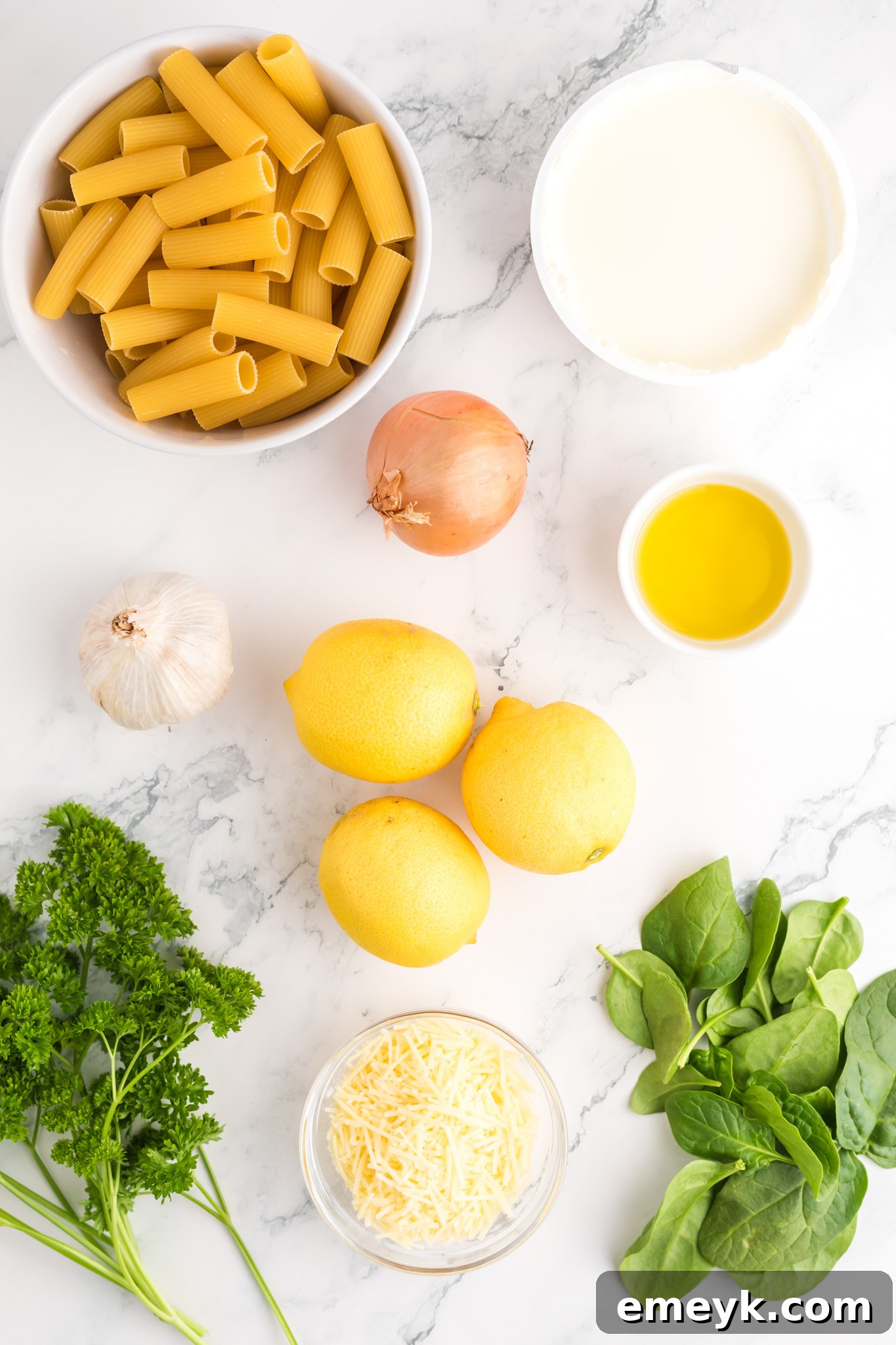 All the fresh ingredients for Lemon Ricotta Pasta laid out on a table.