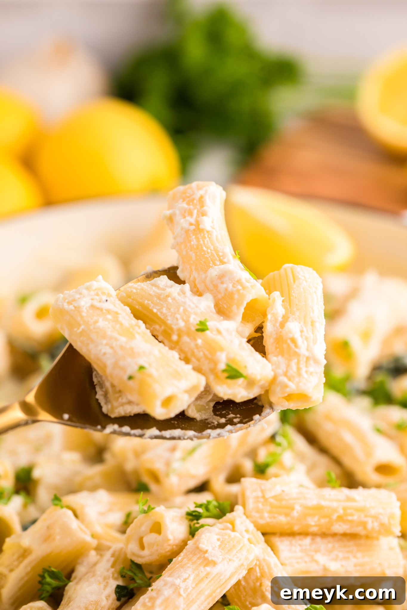 Lemon Ricotta Pasta being scooped with pasta on a spoon.