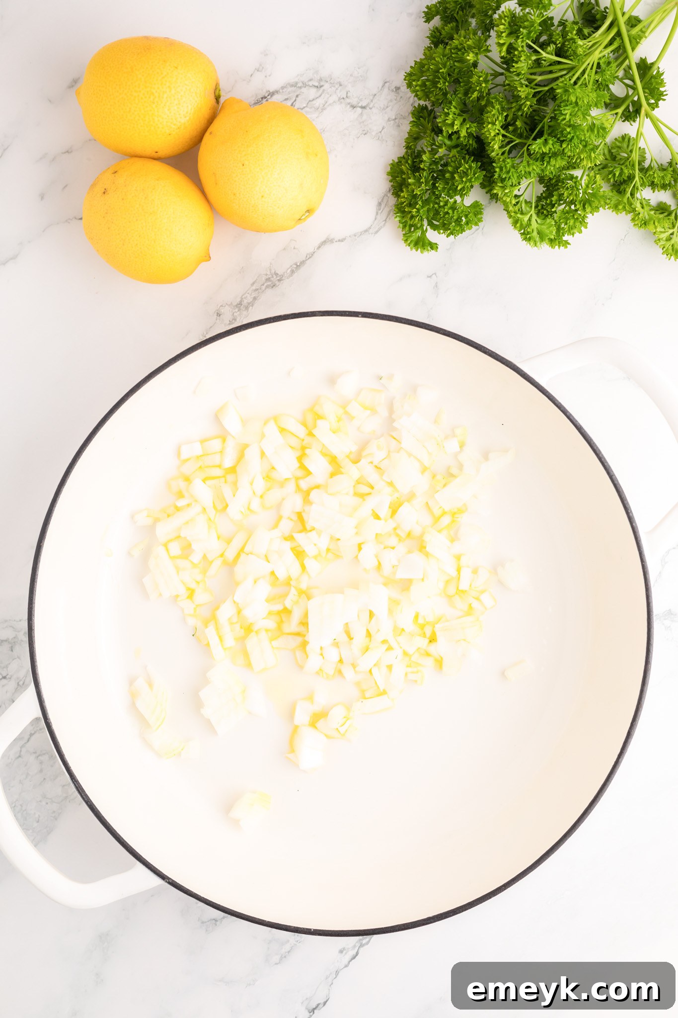 Onions cooking in a skillet for Lemon Ricotta Pasta.