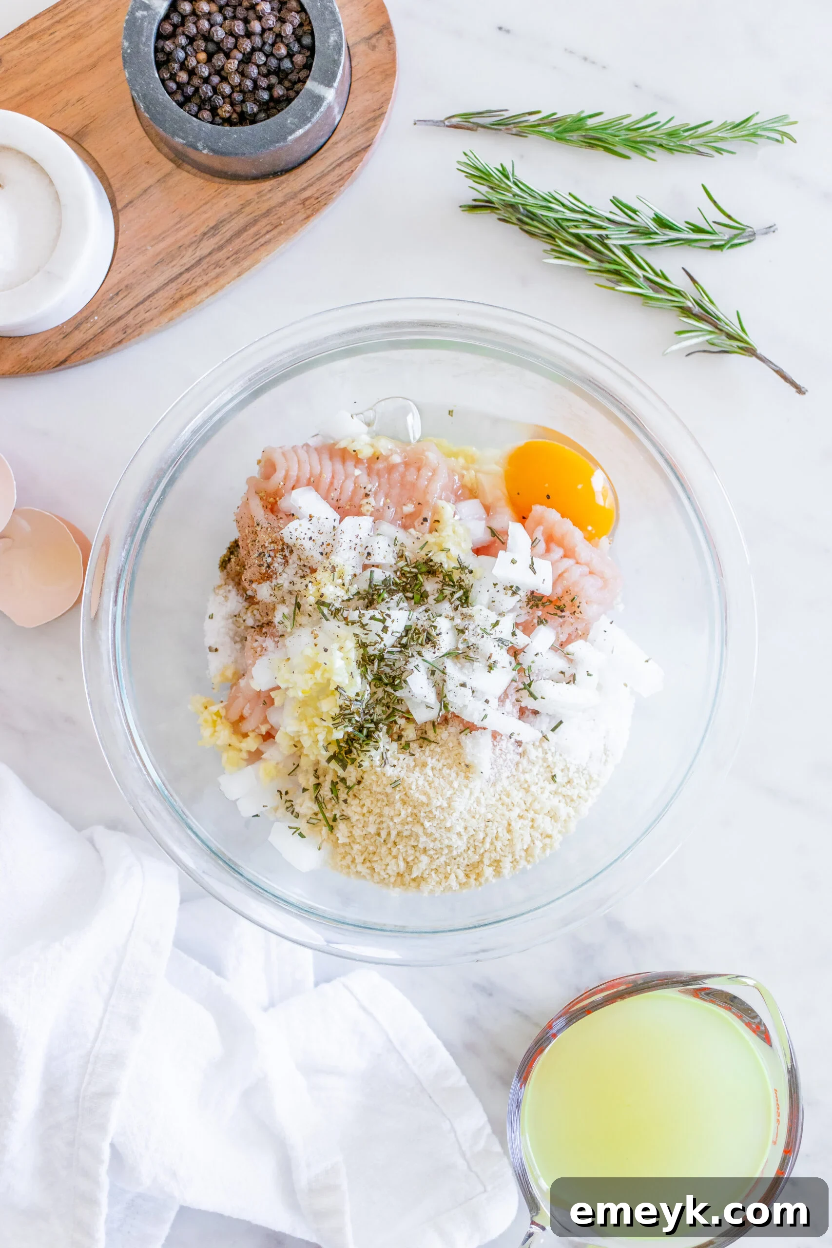 A bowl containing the raw Maple Dijon Turkey Meatball mixture, ready to be formed.