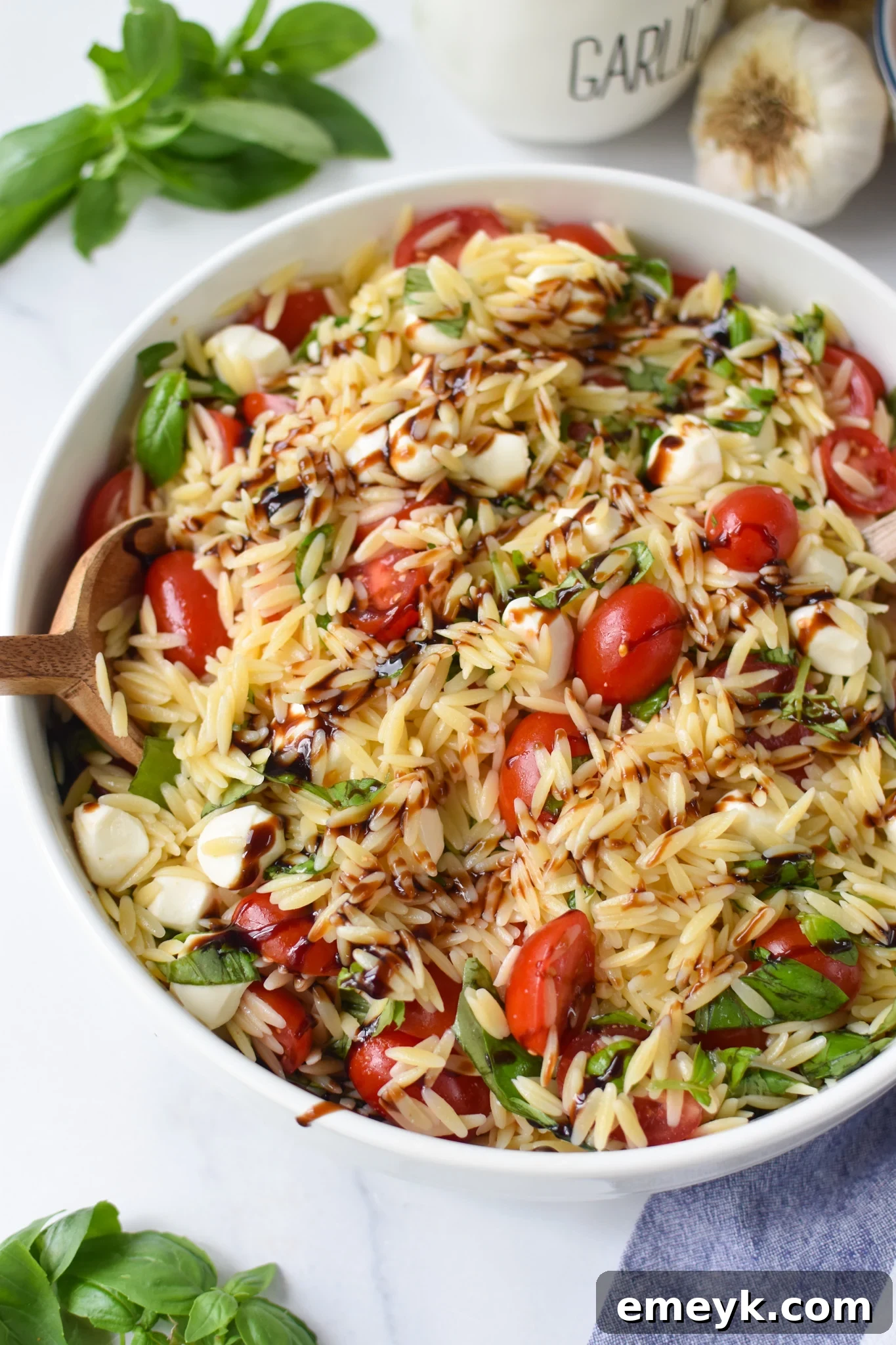 Caprese Orzo Delight 2 Caprese Orzo Pasta Salad with balsamic in a large bowl, ready to serve.