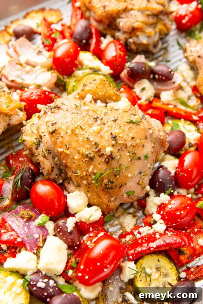 Mediterranean Sheet Pan Chicken on a sheet pan with feta cheese and fresh herbs
