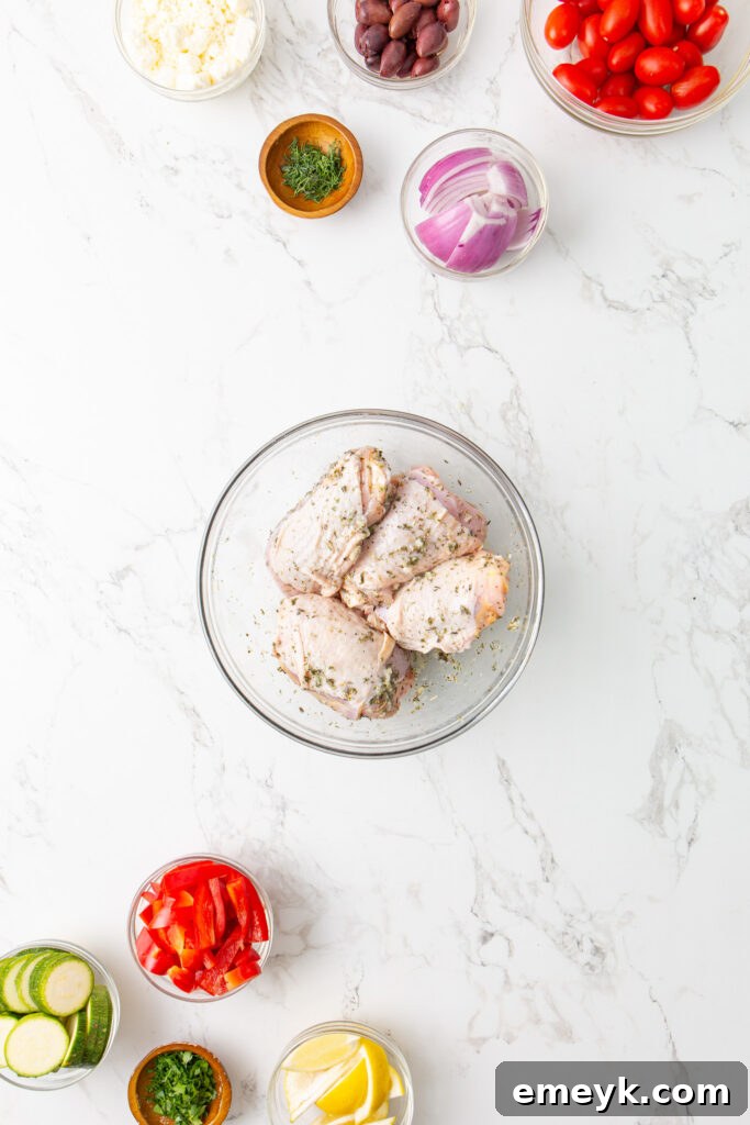 Mediterranean Sheet Pan Chicken ingredients being mixed in a marinade bowl.