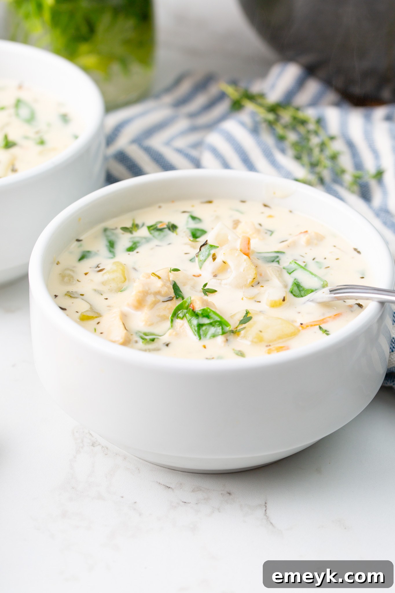 A spoonful of Copycat Olive Garden Chicken Gnocchi Soup, showcasing the creamy broth, chicken, vegetables, and gnocchi.