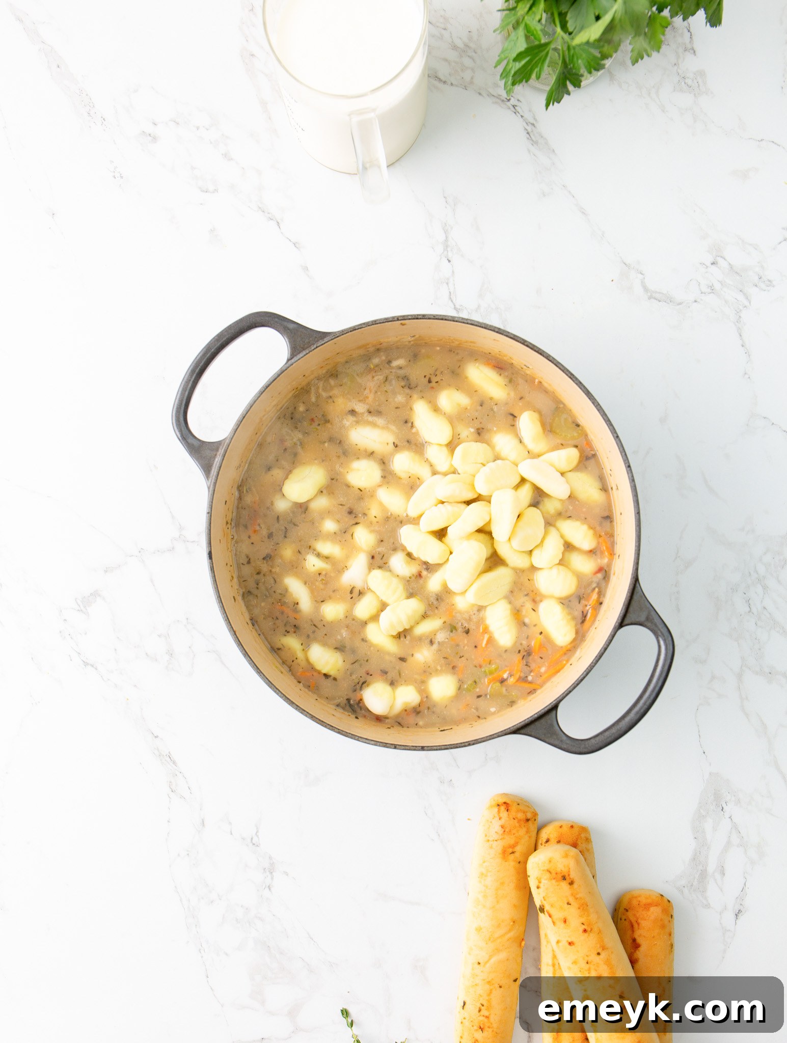 Pillowy potato gnocchi simmering in the creamy broth of the Copycat Olive Garden Chicken Gnocchi Soup, absorbing all the flavors.