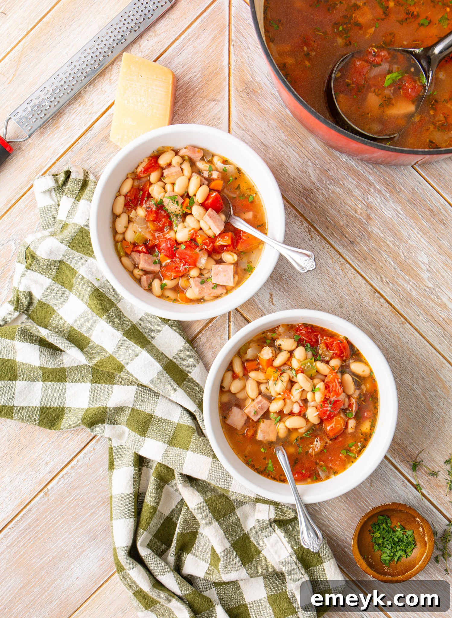 Two cozy bowls of Navy Bean Soup on a rustic wooden surface, ready to be enjoyed.