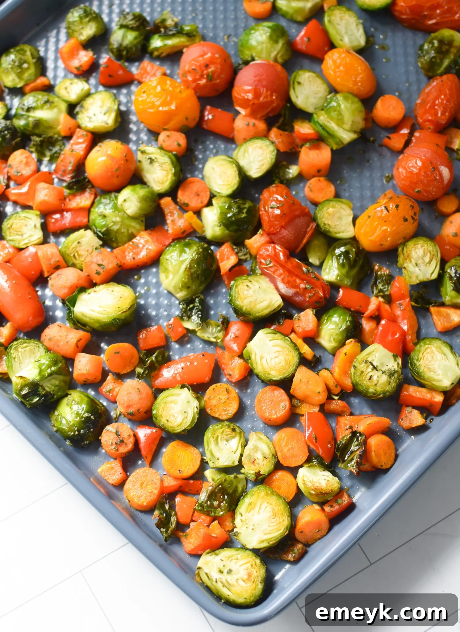 Roasted vegetables on a baking sheet, golden and tender.