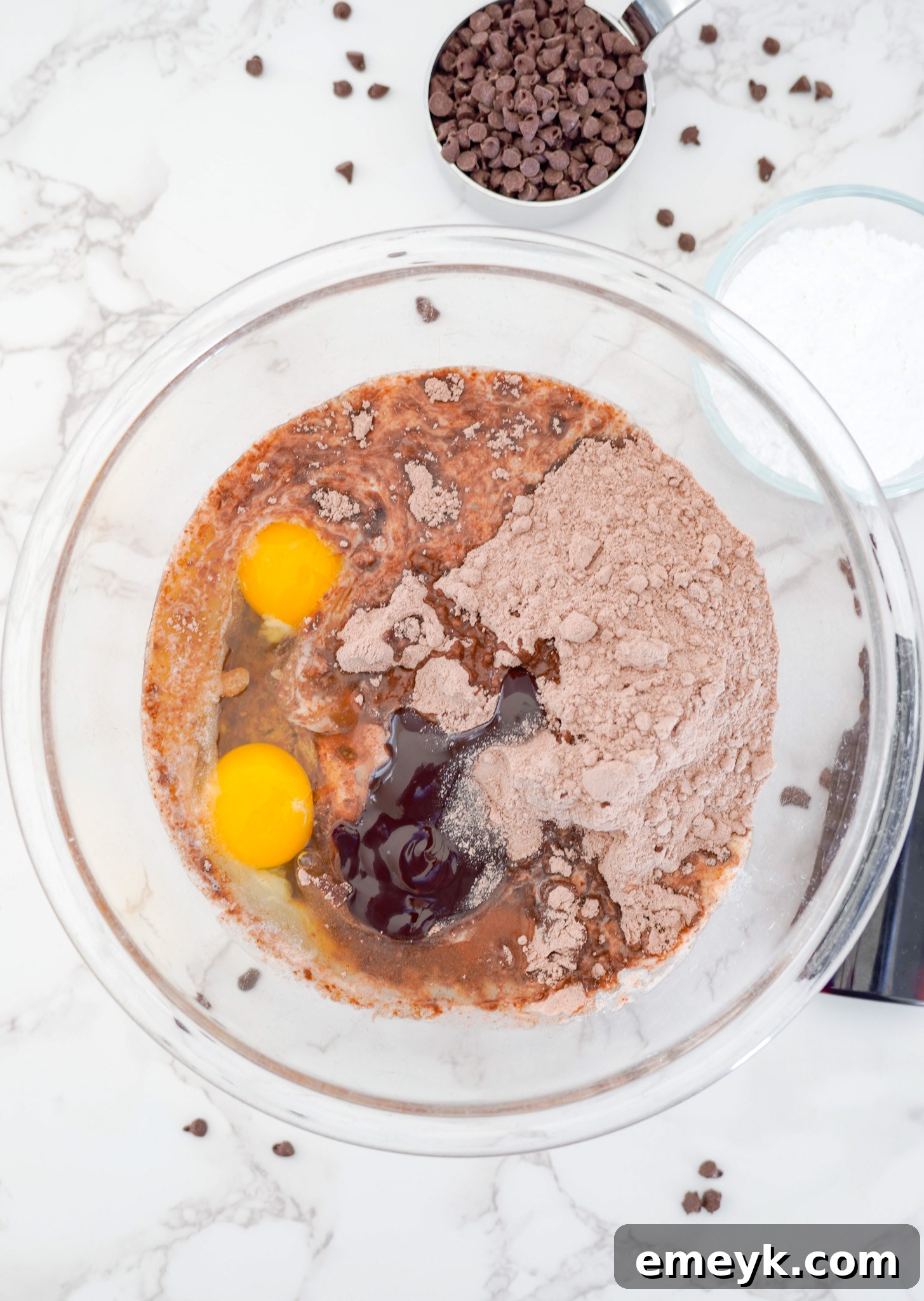Initial ingredients for Chocolate Crinkle Cookies (cake mix, butter, eggs, vanilla, chocolate syrup) in a mixing bowl before combining.