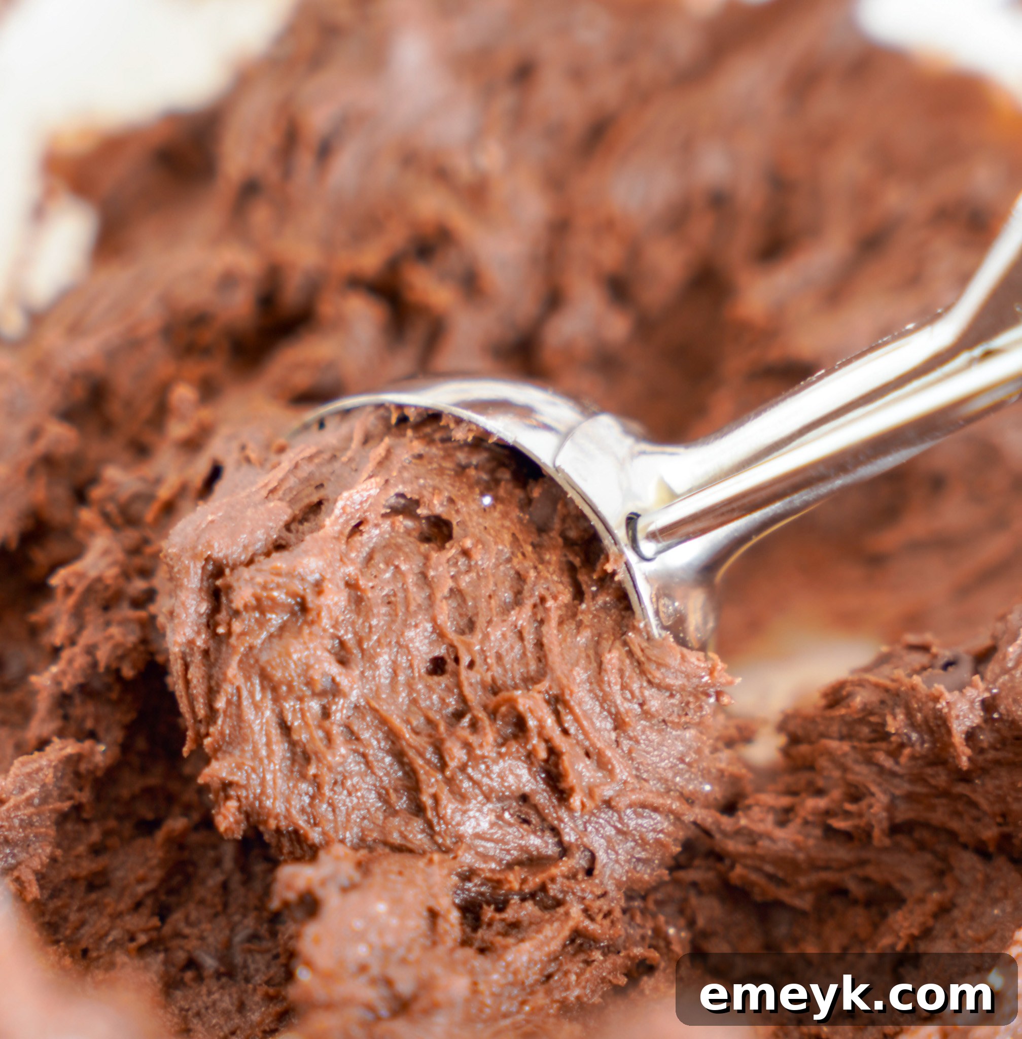 Chocolate Crinkle Cookie dough in a cookie scoop, ready to be rolled into a ball.