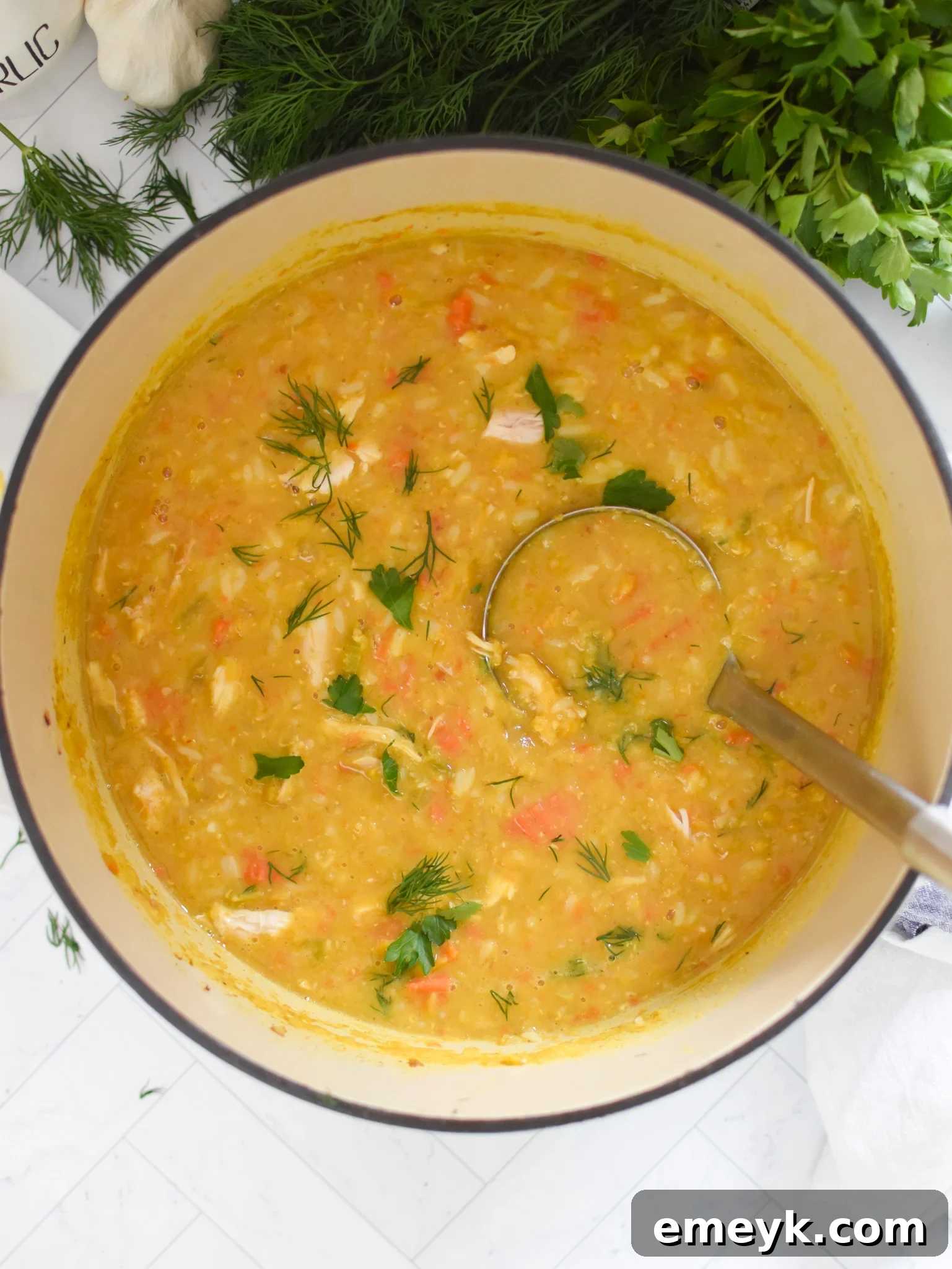 Ladle scooping hot Chicken Lentil Soup from a pot.