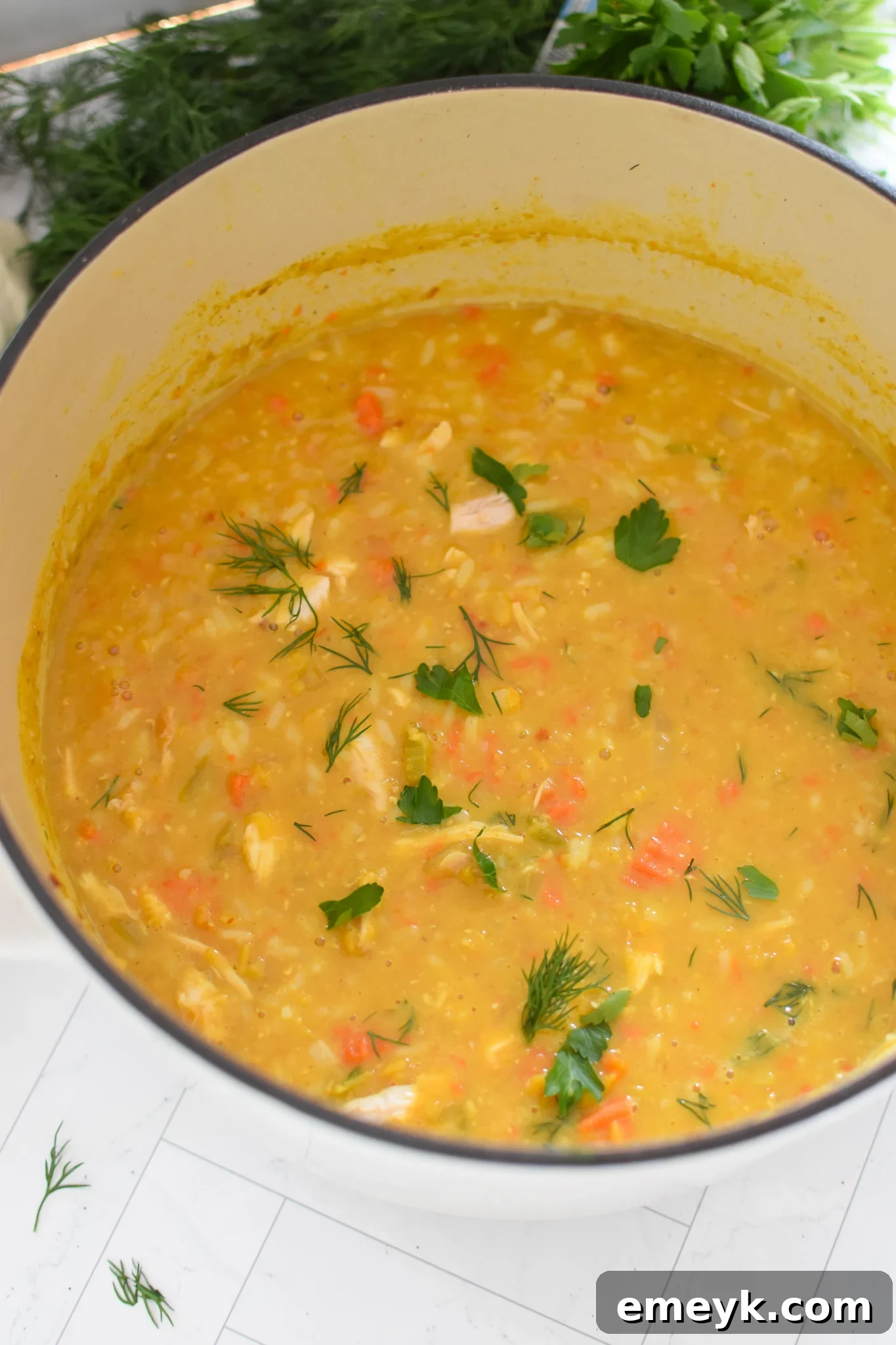 Large pot of Chicken Lentil Soup simmering on the stove.
