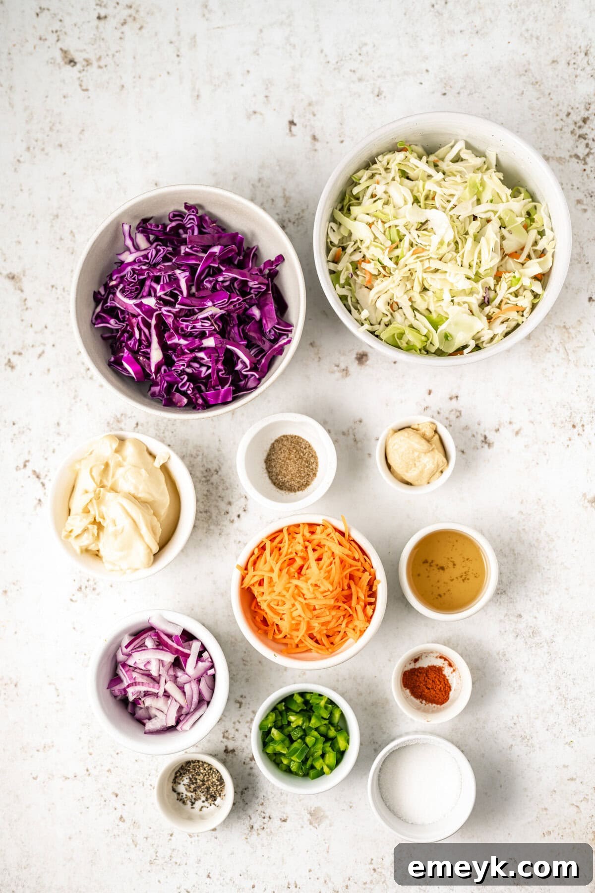 Kickin Jalapeno Coleslaw 6 A vibrant display of fresh ingredients for Jalapeño Coleslaw, including shredded cabbage, carrots, and whole jalapeños.