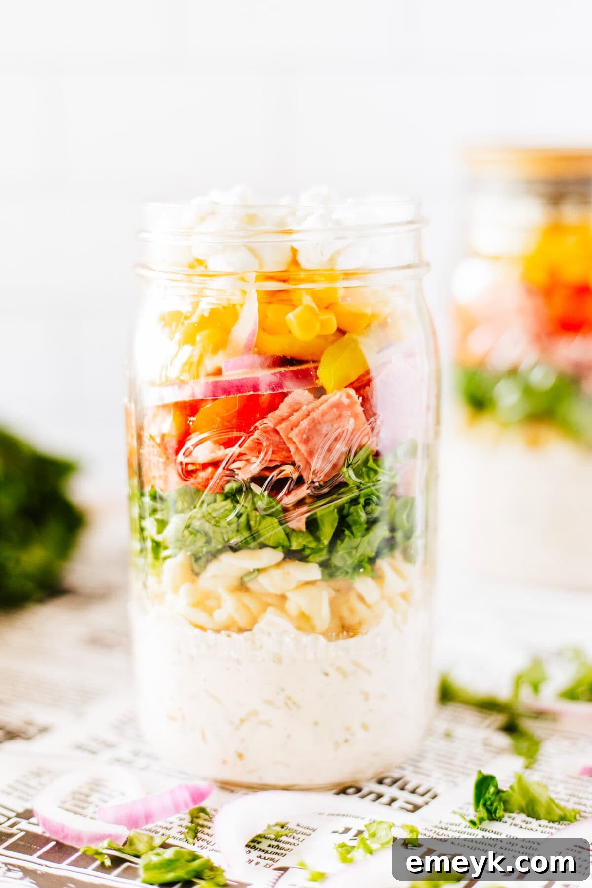 A single Italian Pasta Mason Jar Salad, showcasing the beautiful layers of ingredients within the glass jar, ready to be shaken and enjoyed.
