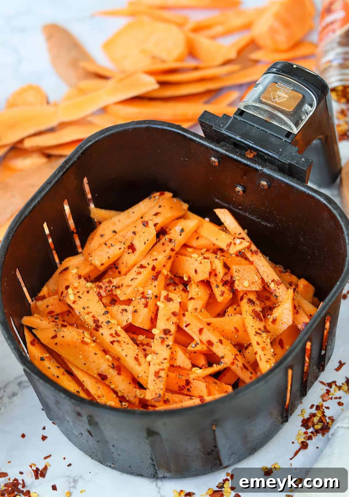 Finished crispy Air Fryer Sweet Potato Fries in an air fryer basket