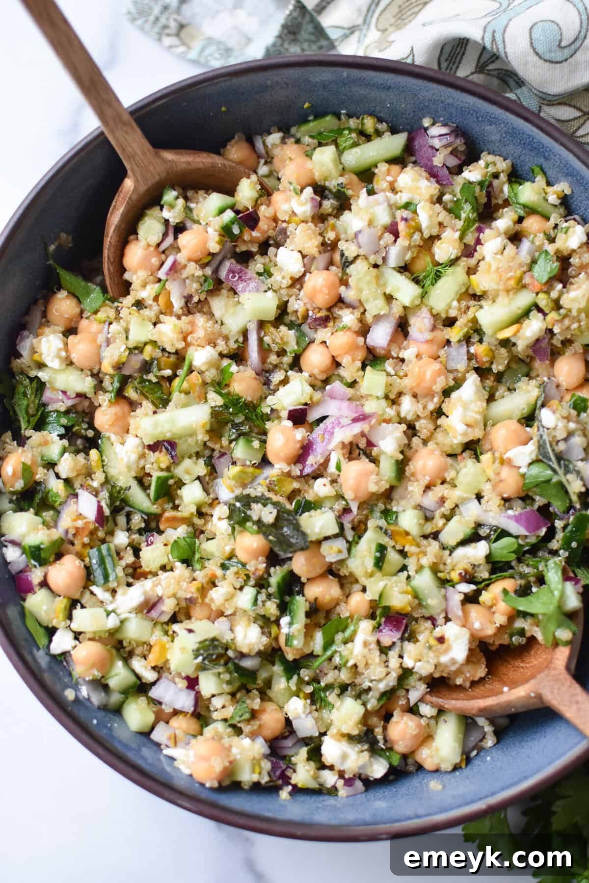 The Secret to Jennifer Aniston's Viral Salad Sensation 2 salad ingredients mixed in a blue bowl.