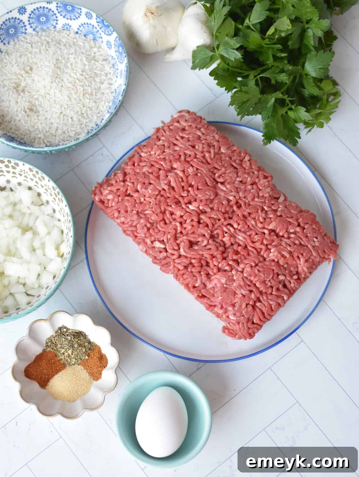 Rice Spiked Meatballs 4 Fresh ingredients laid out for making Porcupine Meatballs, including ground beef, rice, and spices.