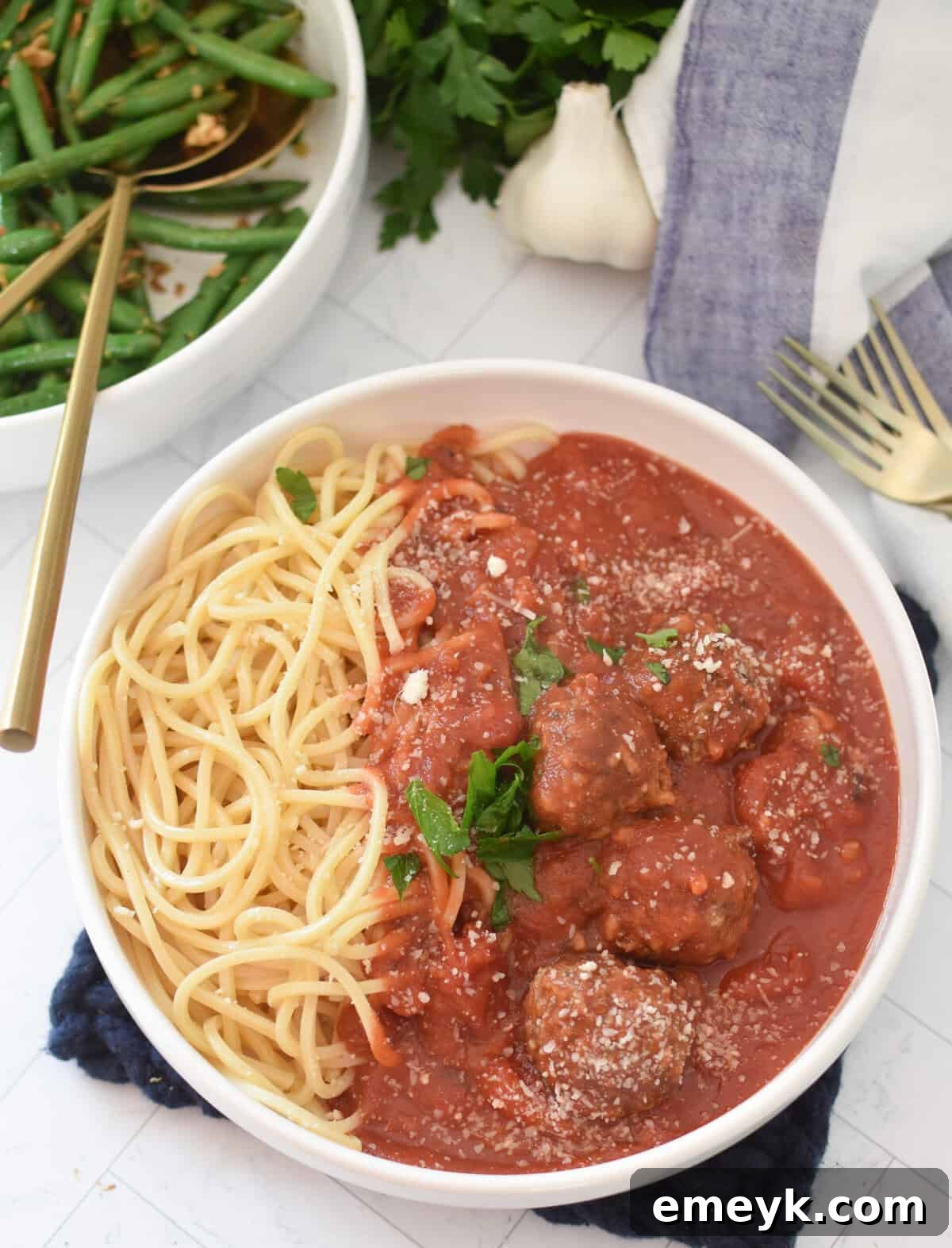 Rice Spiked Meatballs 5 Cooked Porcupine Meatballs in a white serving bowl, ready to be enjoyed.