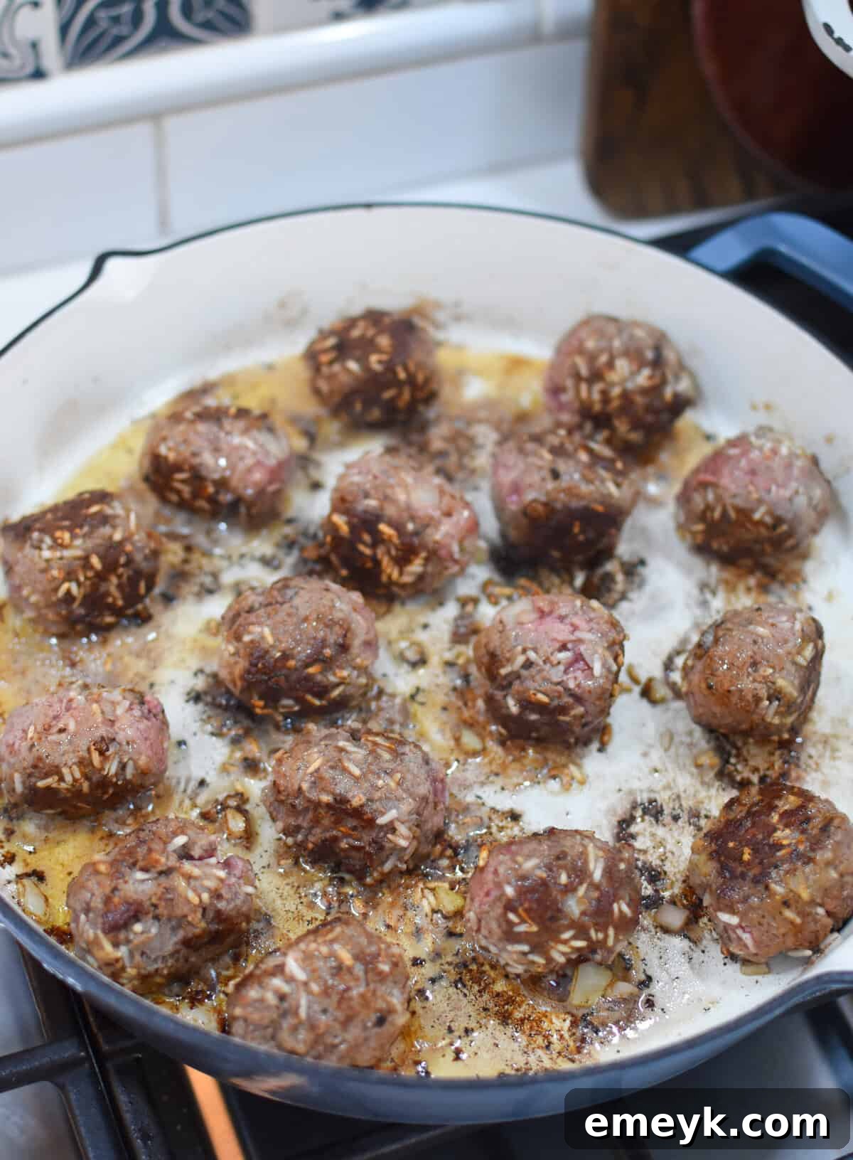 Rice Spiked Meatballs 8 Porcupine Meatballs browning in a hot skillet with olive oil.