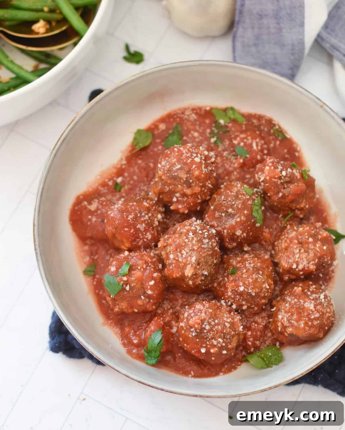 Rice Spiked Meatballs 10 Porcupine Meatballs in a bowl, garnished with fresh parsley.