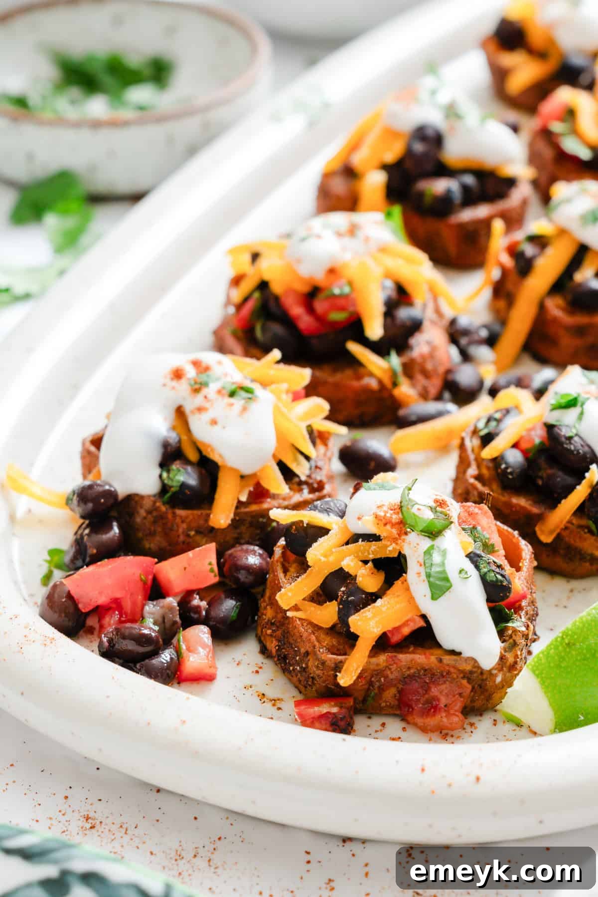Platter of Southwestern Roasted Sweet Potato Rounds garnished with cilantro