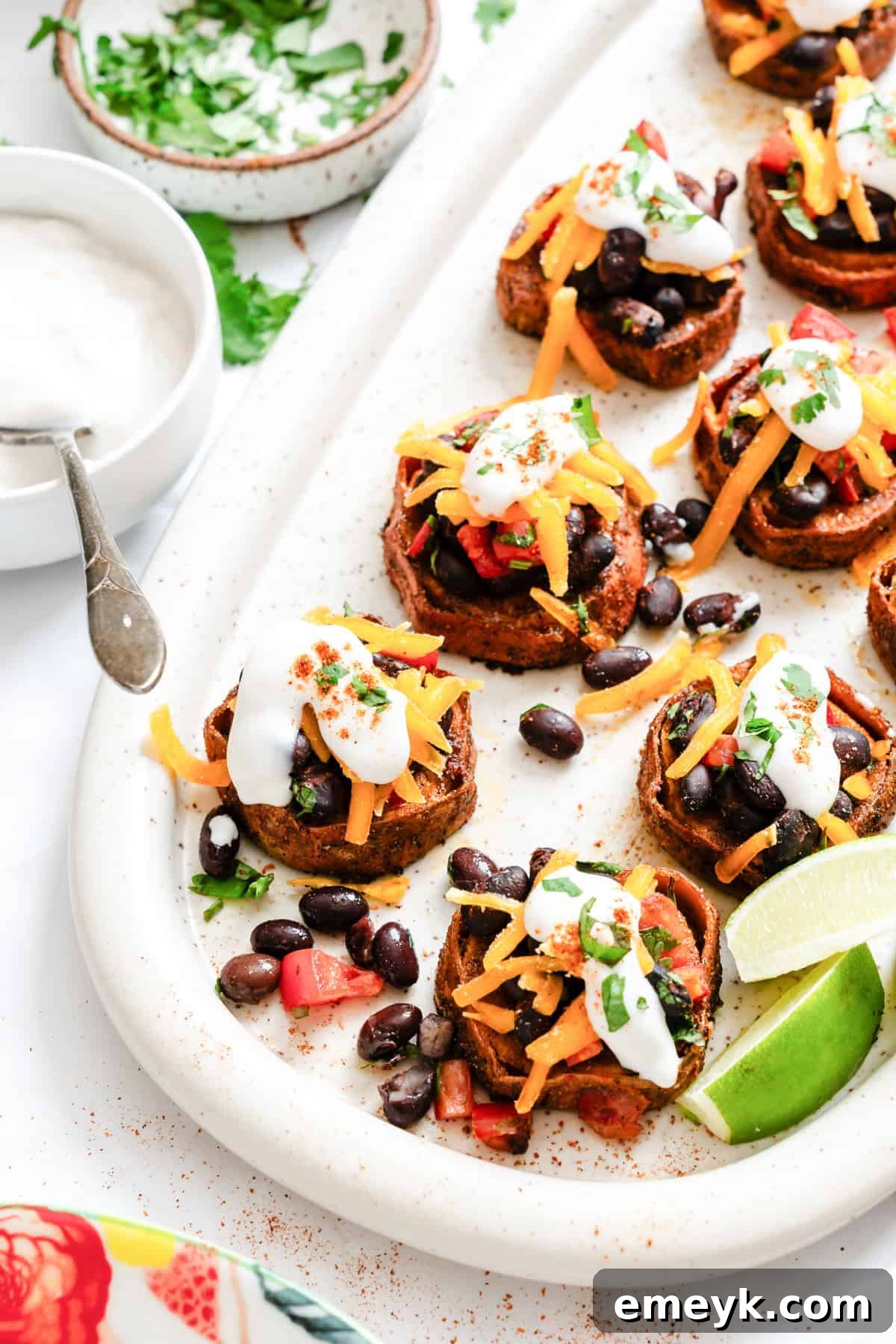 Southwestern Roasted Sweet Potato Rounds garnished with sour cream and cilantro