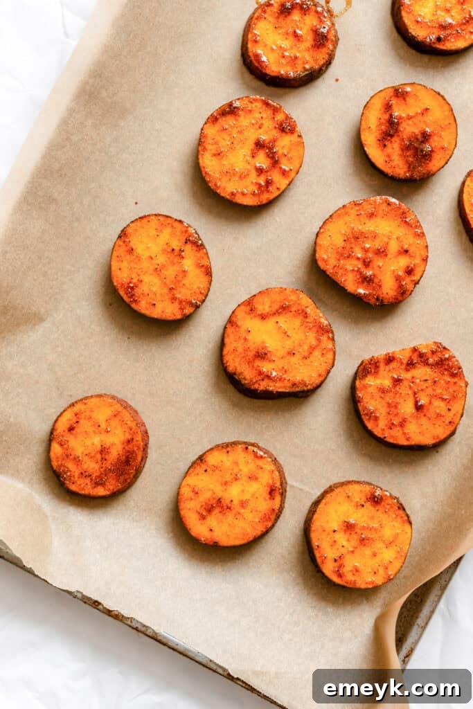 Sweet potato rounds spread on a baking sheet