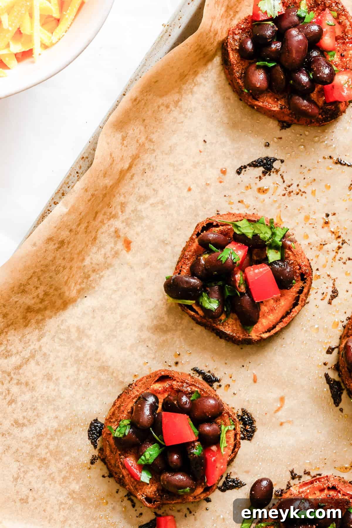 Close-up of a Southwestern Roasted Sweet Potato Round with black bean topping
