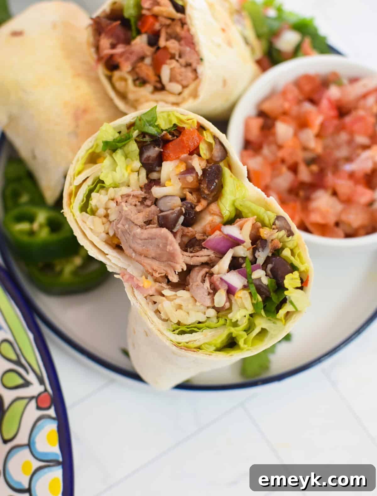 Smoked Pork Burrito Sensations 2 Flavorful Pulled Pork Burritos served beautifully with a side of fresh salsa and lime wedges