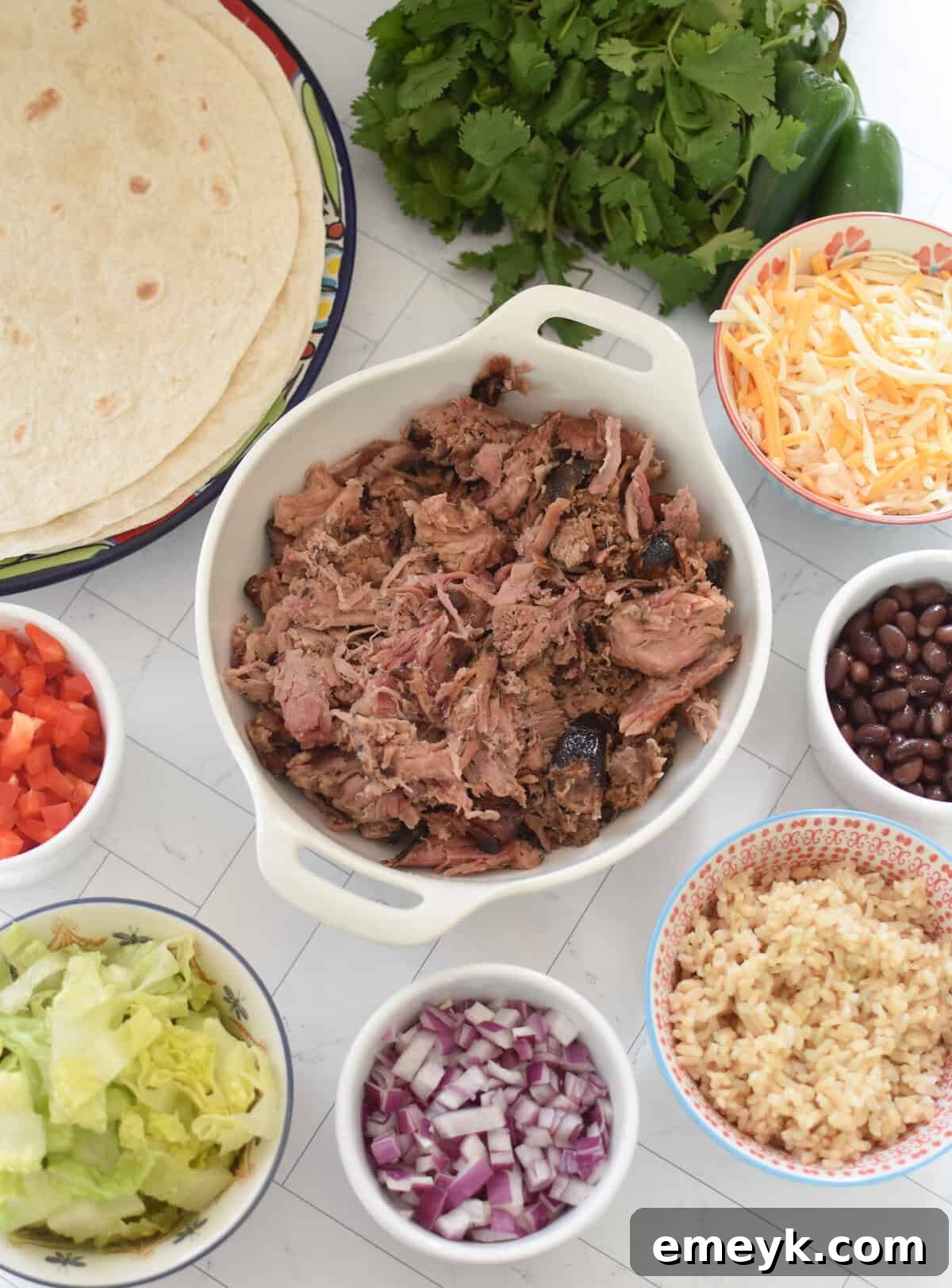 Smoked Pork Burrito Sensations 4 Assortment of fresh ingredients for Pulled Pork Burritos, including vibrant spices, colorful vegetables, and warm tortillas