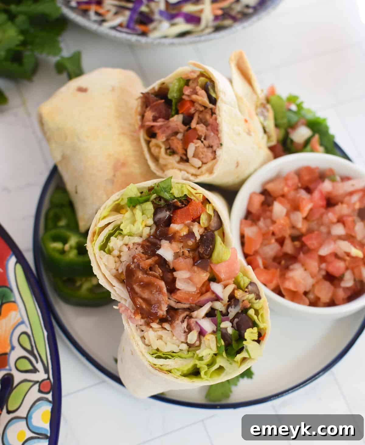 Smoked Pork Burrito Sensations 6 The initial stages of assembling a Pulled Pork Burrito on a clean white plate, showing the layered filling