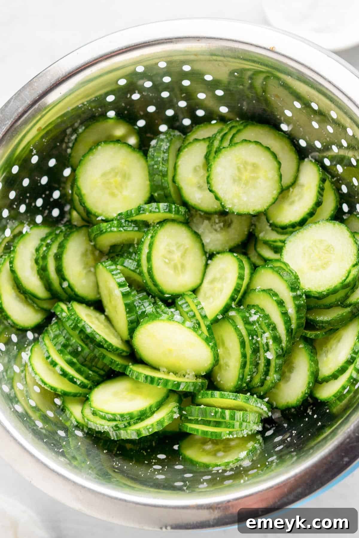 Cucumber Onion Salad cucumbers in a strainer