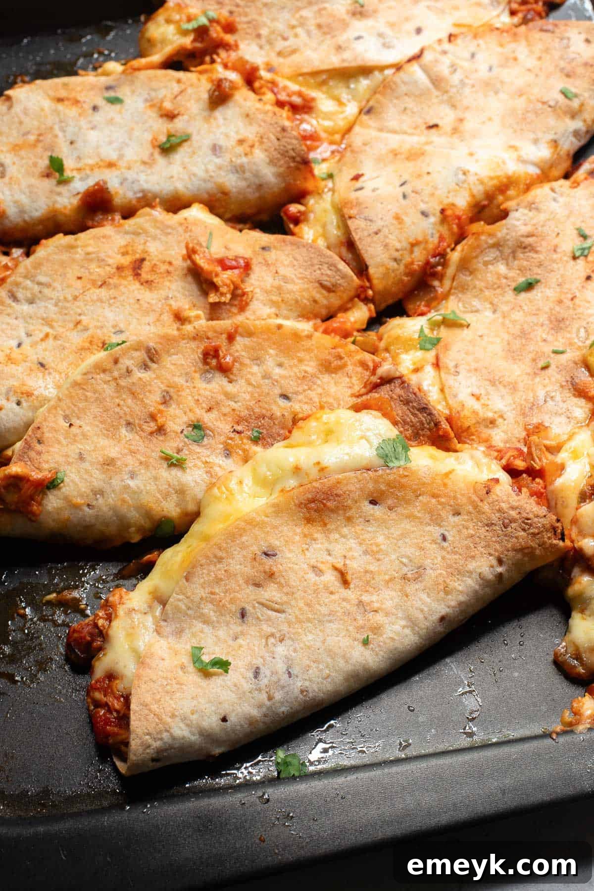 Baked Chicken Tacos arranged on a baking tray, ready for the oven