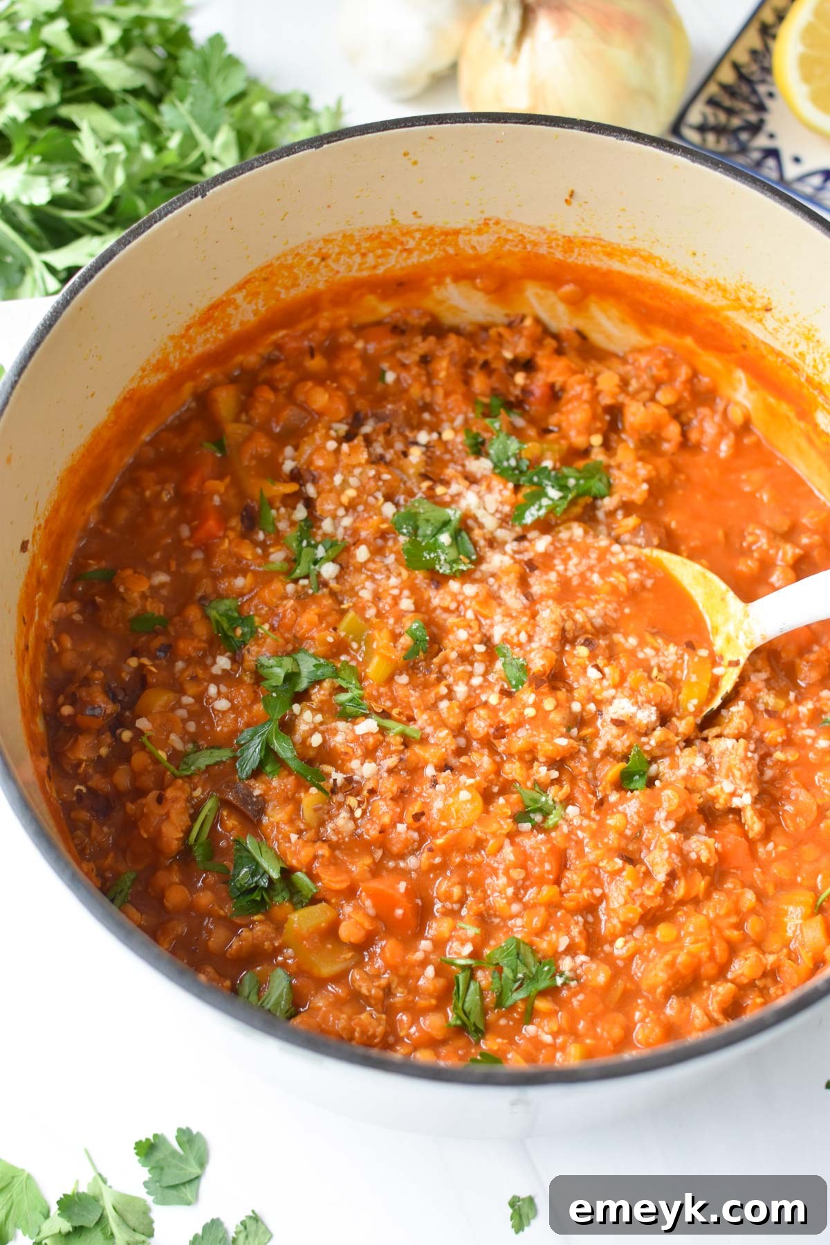 A serving of hearty Lentil Sausage Soup with a spoon