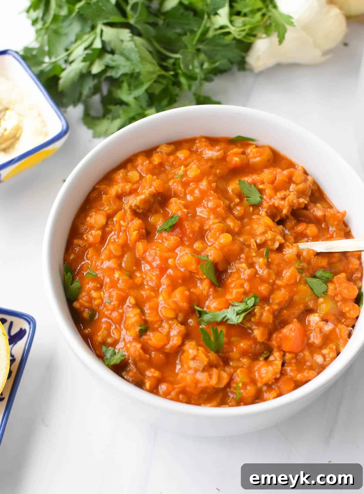 Lentil Sausage Soup garnished with fresh parsley