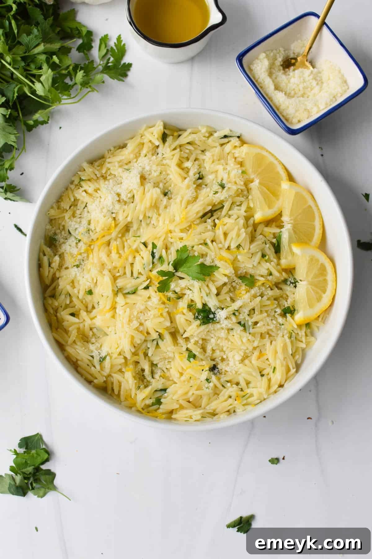 Lemon Orzo served in a rustic white bowl, garnished with fresh herbs.