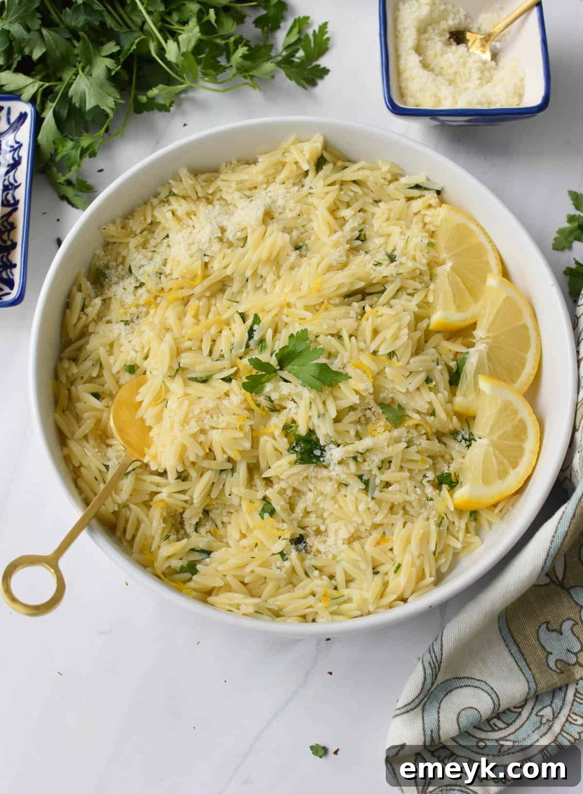 A bowl of Lemon Orzo with a golden spoon, ready to be enjoyed.