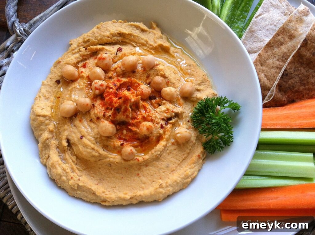 Spicy hummus served with fresh carrot sticks, a healthy and crunchy dipping option