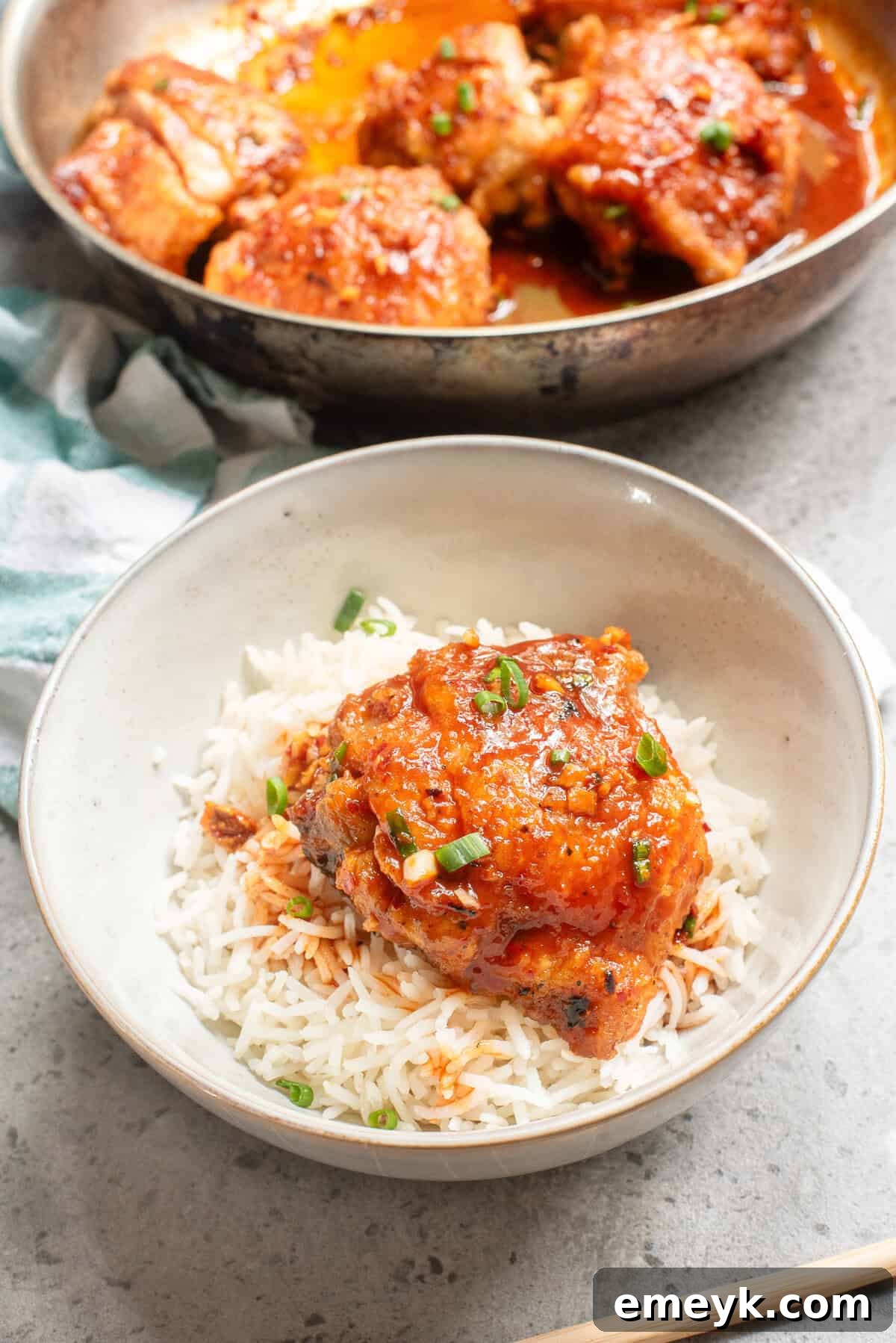 Honey Ginger Chicken served in a rustic bowl, garnished with sesame seeds and fresh cilantro.