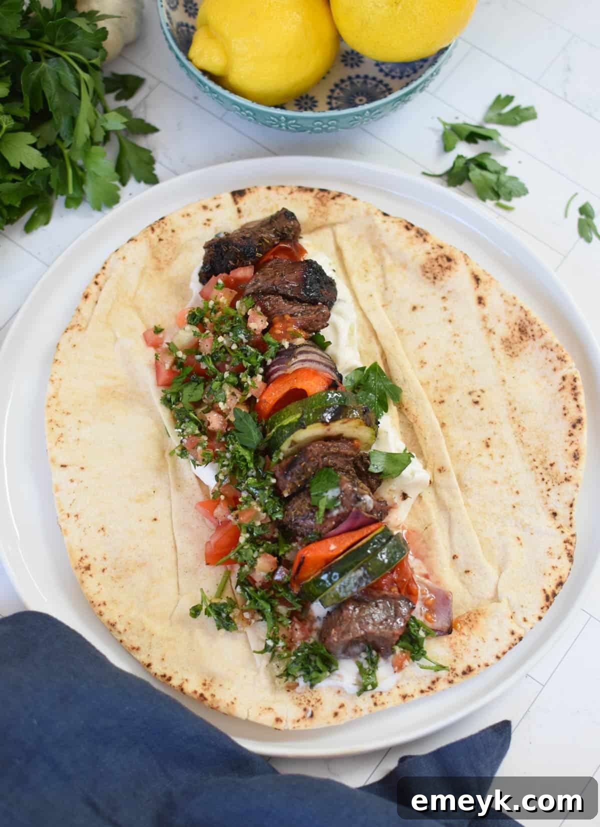 Beef Souvlaki served in a warm pita bread with creamy tzatziki and fresh vegetables.