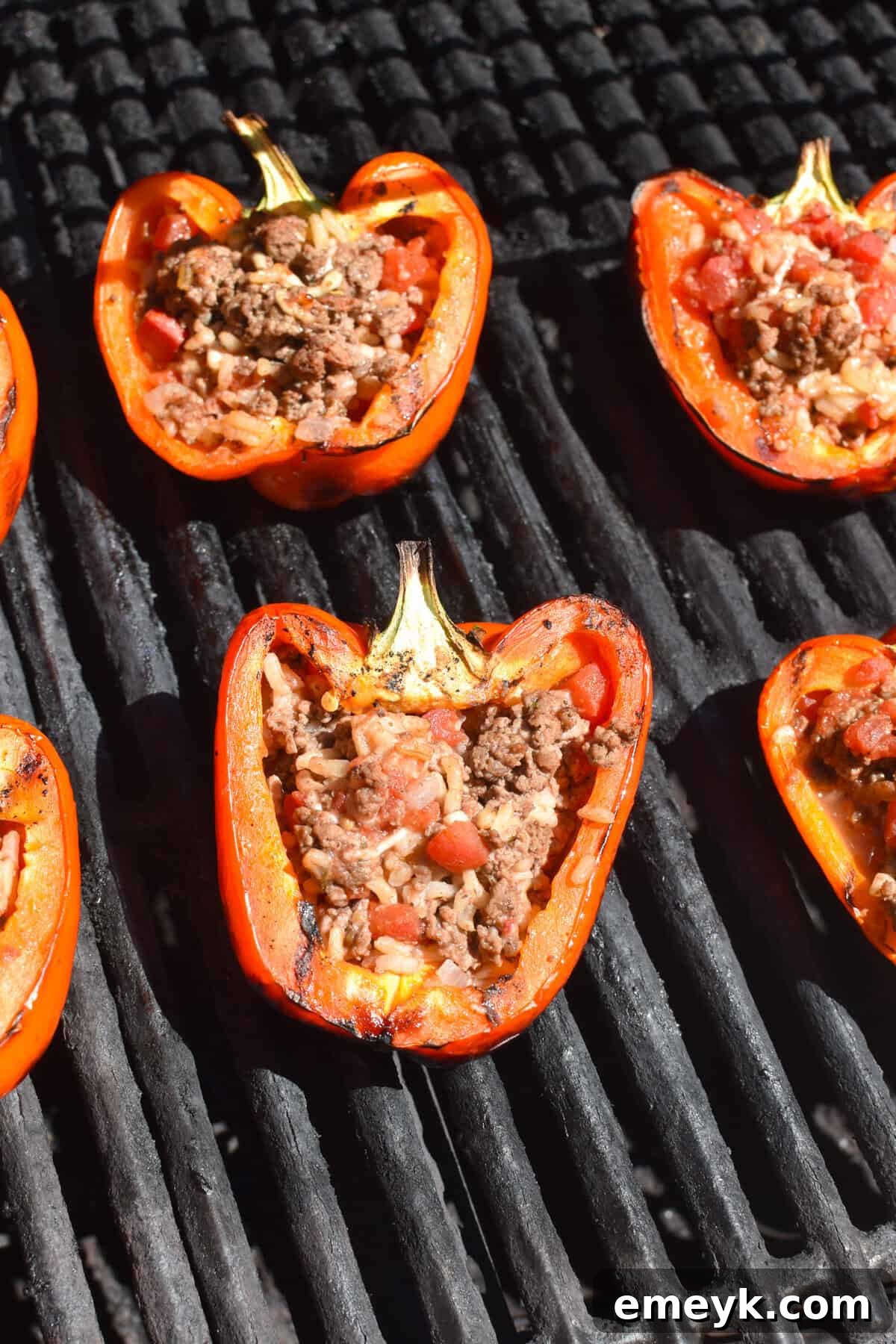 Grilled Stuffed Peppers cooking on the grill, with a slight char.