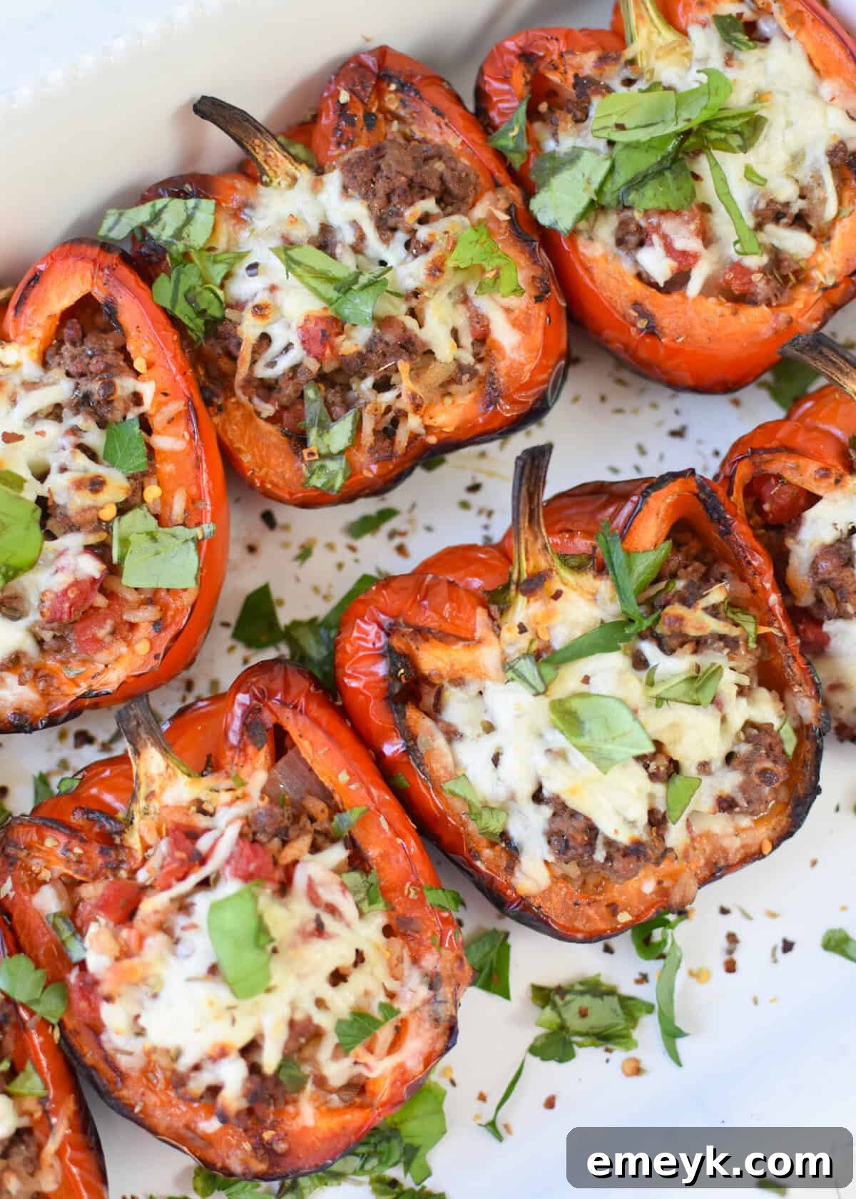 Grilled Stuffed Peppers on a white plate ready to be served.