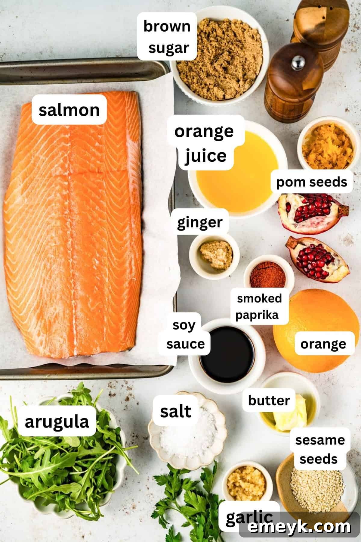 All the fresh ingredients laid out for making Orange Glazed Salmon, including salmon fillets, oranges, garlic, ginger, and spices.