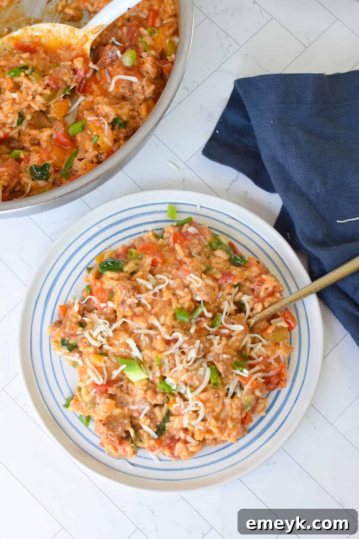 A serving of Creamy Cajun Sausage Rice Skillet on a white plate